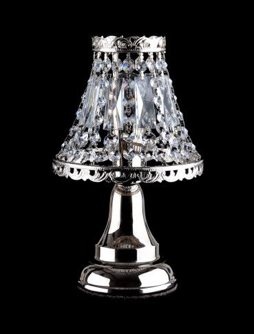 A small silver lamp made of strass stones for a bedside table