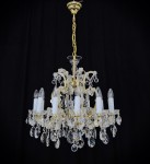 A general view of a hanging terezian chandelier made of gold metal