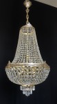 The strass chandelier also includes a decorative chain and a ceiling rose