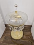 The lamp glass is set in cast brass