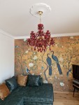 Installation of a ruby red crystal chandelier in the interior of the apartment (without light bulbs).