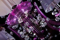 The light bowl of the chandelier is made of purple glass