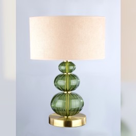 A discreet table lamp made of dark green glass in the color of a fallen star (Moldavite).