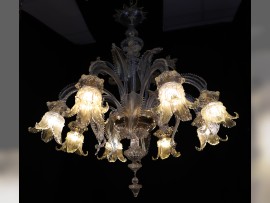 The light highlights the golden hue of the glass parts of the period chandelier