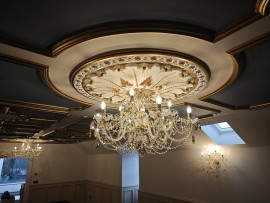 Luxuriously decorated low spaces in the attic of a house with colorful crystal chandeliers