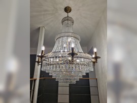 Chandelier in the shape of a rhinestone basket with arms in the interior