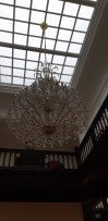 Dark interior of a villa with an extinguished chandelier