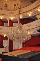 Lowering the chandelier to the floor of the theater for service