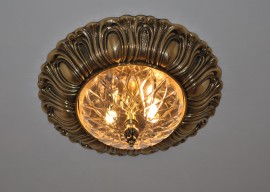 Lit-on gold surface mounted chandelier with cut glass