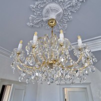 A smaller chandelier on the ceiling of the kitchen