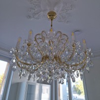 12-arm chandelier in a white kitchen