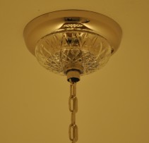 Ceiling rose of the chandelier with a crystal cover