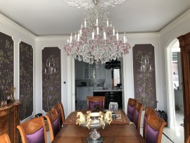 Pink chandelier of Maria Theresa over a wooden table