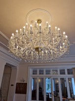 A luxurious crystal chandelier with a diameter of 165 cm decorated with a rosette