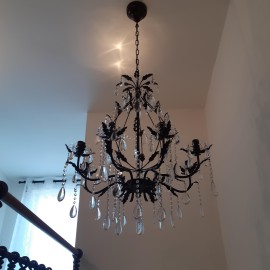 The brown crystal chandelier in the color of a stair railing