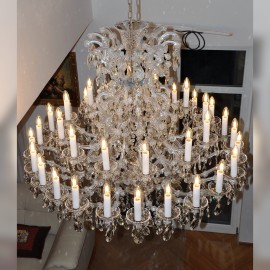 Installation of a large 36-flames Theresian chandelier with adjustable height