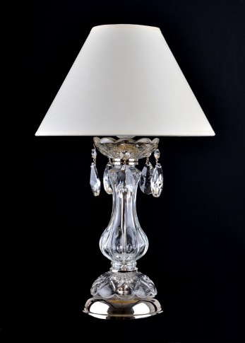 Glass lamp on the bedside table in the bedroom with lampshade - silver metal