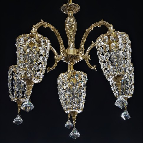 Cast brass chandelier consisting of six crystal baskets.