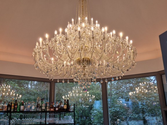 Amazing mirror effect of crystal chandelier in cafe windows