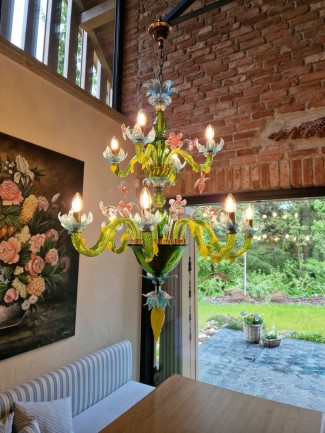 Murano chandelier matching the brick wall and tapestry