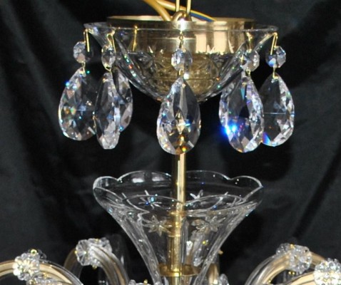The glass cover of the ceiling rose decorated with crystal almonds