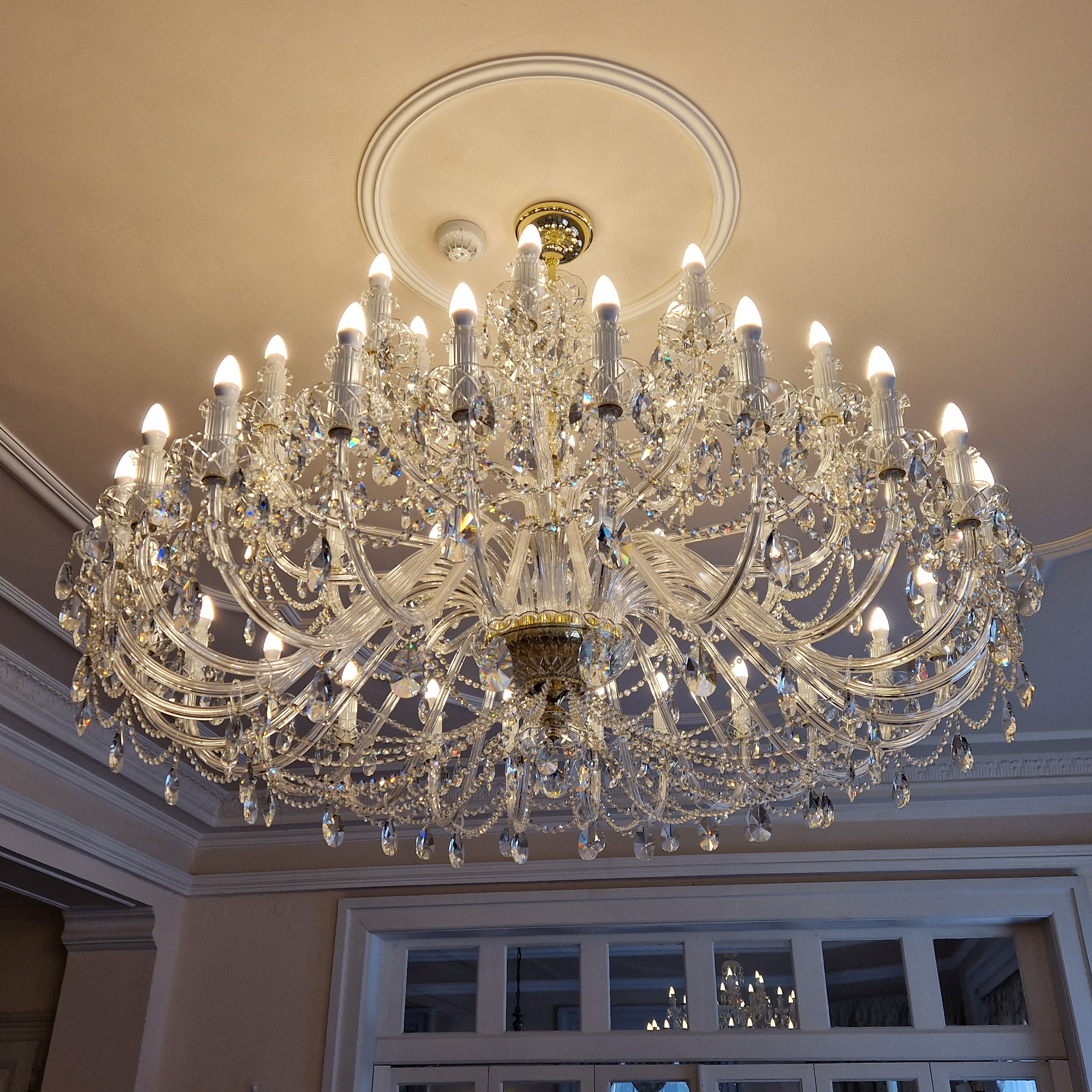 Installation of a large crystal chandelier with a diameter of 165